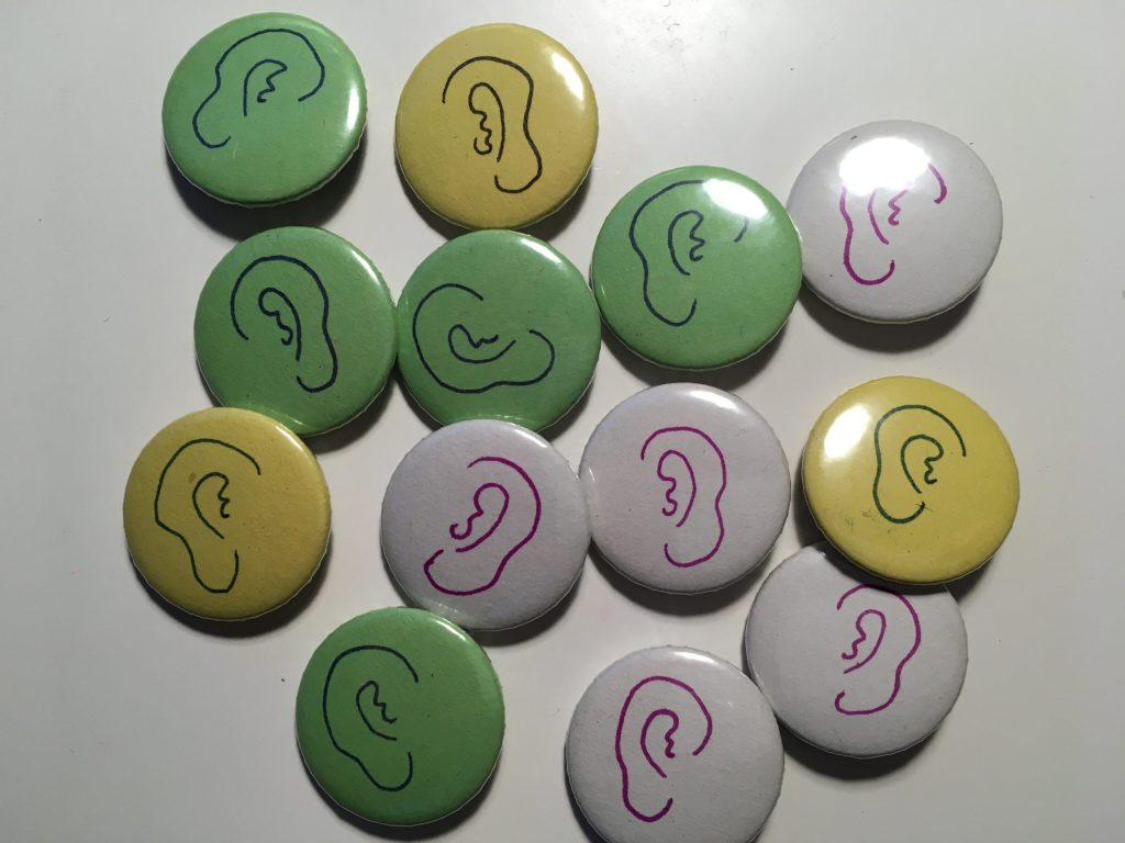 Badges with green, yellow and white backgrounds with hand-drawn Poundbury Ears