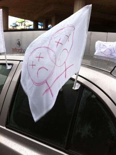 Car banner with drawing of sad women's symbols