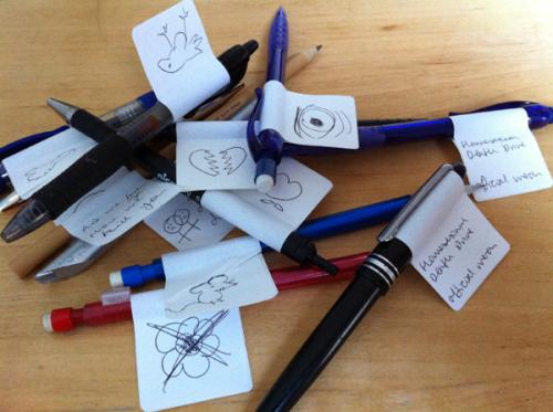 Pile of pens with hand drawn tags